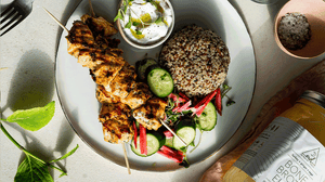 Yogurt marinated chicken skewers served with sprouted quinoa and a radish & cucumber salad