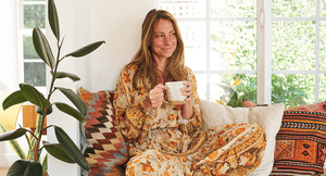 Lindsey Wilson, OWL Founder, drinking organic bone broth elixir in a bay window