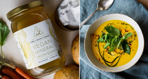 Carrot Jicama Gazpacho served in a bowl, garnished with fresh greens and herbs, paired with Organic Vegan Mineral Broth Elixir jar and fresh vegetables