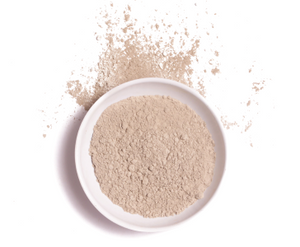 Bentonite clay for bone broth displayed as fine beige powder in a white bowl with scattered powder around it