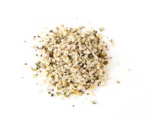 Hemp seeds for bone broth displayed as a small pile of shelled seeds on a white background