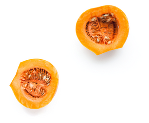 kabocha squash for Bone broth displayed as two orange squash halves with seeds on a white background