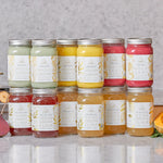 Broth cleanse featuring an assortment of bone broth elixirs and nutrient-rich mylkshakes in glass jars with silver lids.